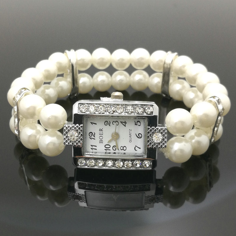 Reloj femenino de cuarzo con pulsera elástica de perlas vista frontal