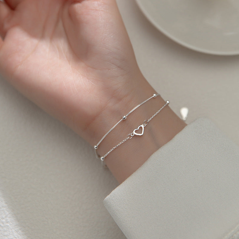 Pulsera doble cadena ajustable con pequeños corazones y esferas metálicas para mujer