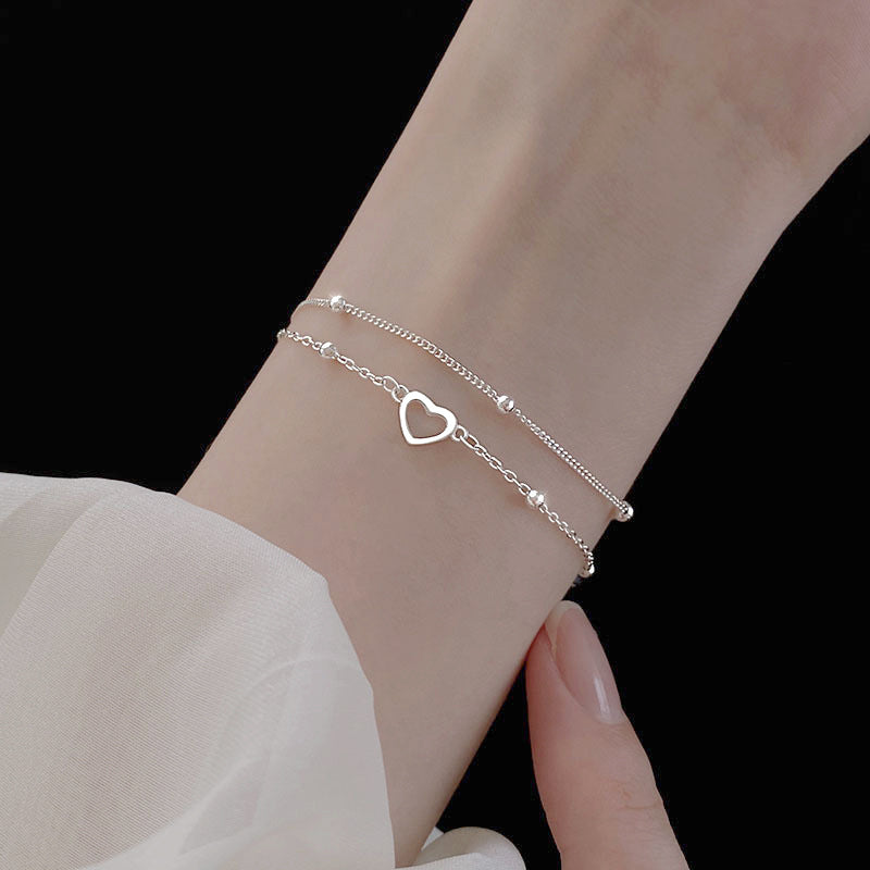 Pulsera doble cadena ajustable con pequeños corazones y esferas metálicas para mujer