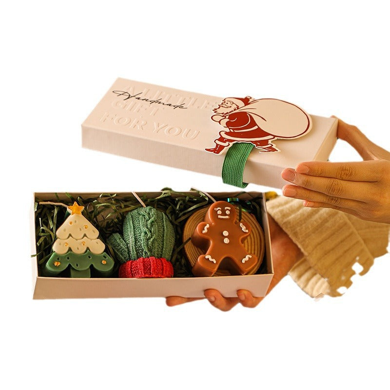 Set de tres velas navideñas aromáticas con diseños decorativos