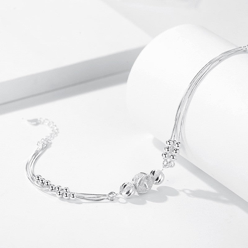 Pulsera Ajustable de Varios Hilos con Bolitas Metálicas – Estilo Elegante para Mujer