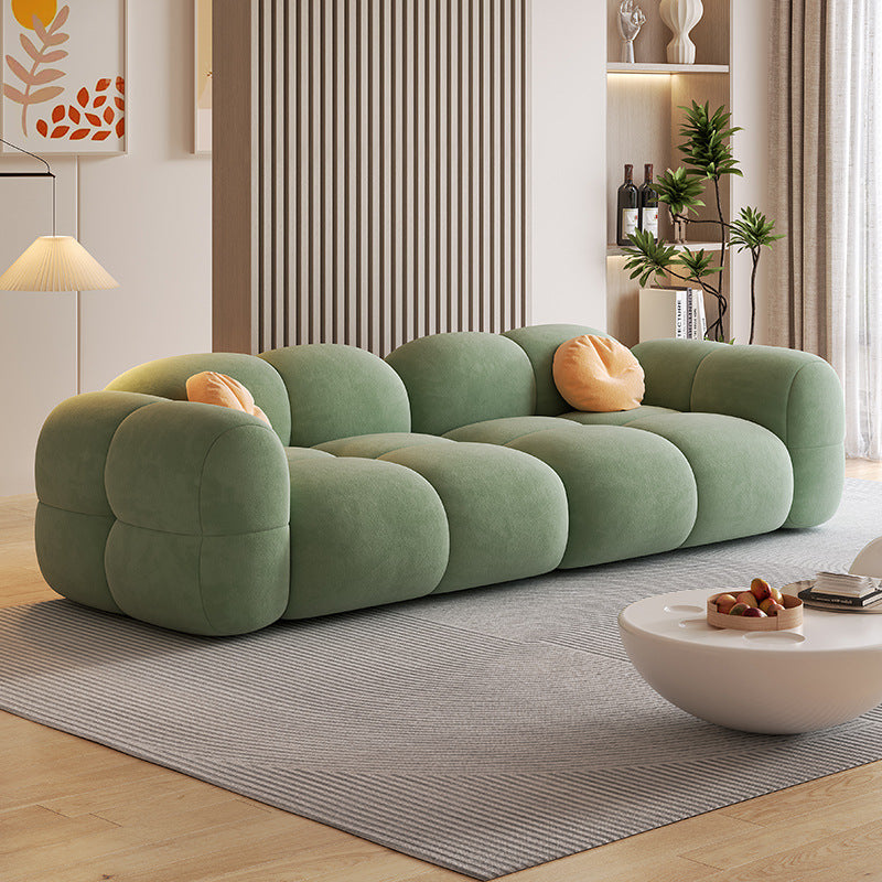 Sofá modular estilo crema tapizado en terciopelo suave